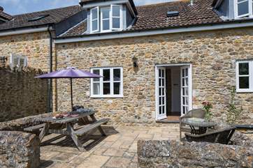 The French doors from the sitting/dining-room lead out onto the sheltered patio.