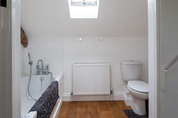 The spacious en suite bathroom has a hand held shower.