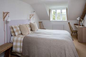 The master bedroom has a generous 5ft bed with gorgeous linens and an en suite bathroom.