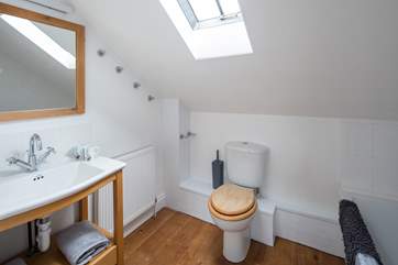 The spacious family bathroom has a shower over the bath.