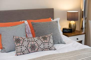 Plenty of cushions for relaxing in bed.