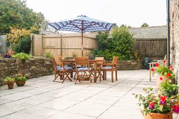 The spacious patio at the rear of the cottage is accessed from both sitting-room and kitchen..