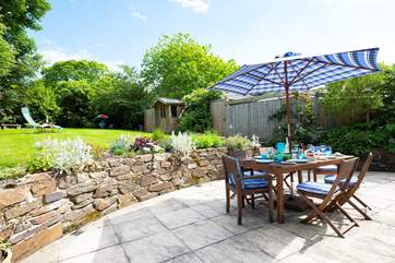 The spacious patio at the rear of the cottage is accessed from both sitting-room and kitchen..