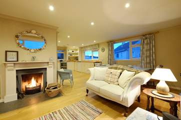 Sofas flank the open fire in the sitting-area.