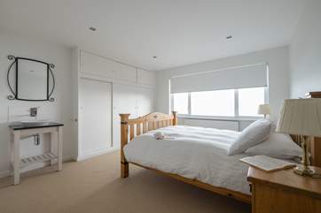 Bedroom 1 has a double bed and a wash-basin.