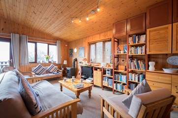 The open plan living-room has a wood-burner effect gas stove.