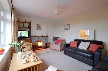 The sitting-room has an open fire.