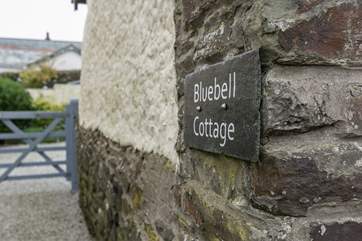 The driveway leads through the gate to a parking area and the courtyard garden.