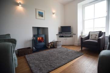 The sitting-area is home to a roaring wood-burner.