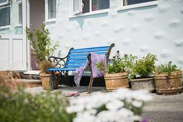 Sit on a bench by the house or in one of the many areas around the split-level gardens.