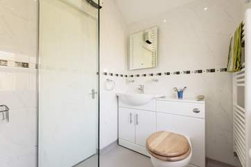 The wet-room is located just off the sitting/dining-room, accessed through a narrow door, part of the original railway carriage.
