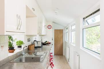 The well-equipped galley kitchen is in keeping wtih the railway theme.