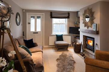 The sitting-area has luxurious furnishings and a cosy wood-burner, perfect for relaxing with a good book or a glass of wine.