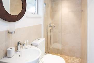The ground floor shower-room has a large shower with drench head, perfect after a trip to the beach or a day spent sailing.