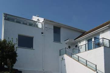 Steps lead from the parking-area to the front door (door on the left with the porthole) and The Poop Deck's balcony is to the left of the photograph.