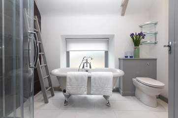 The family bathroom on the first floor with a deep double-ended bath as well as a shower cubicle. The hand held shower attachment has been removed.
