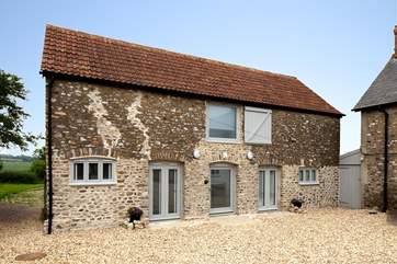 The Cow Shed is a superb top quality barn conversion with a huge terrace and hot tub at the back, and views for miles.