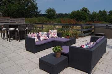 This is the view across the terrace from the other direction - showing the table and chairs for al fresco dining. A gate in the wooden fence leads to the paddock