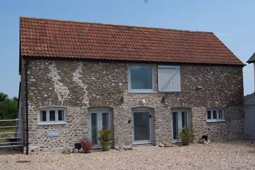 The Cow Shed is a superb top quality barn conversion with a contemporary interior, views for miles from the terrace and a great hot tub.