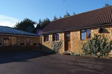 The Cottage in relation to the stunning pool house to the left. Parking is right outside your front door.