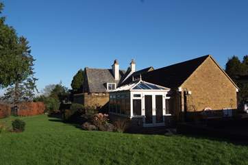 The Cottage is in the foreground ( the owner's home is beyond but you have plenty of privacy) with the freedom of approximately 1.5 acres of fully enclosed gardens to enjoy and your own patio area.