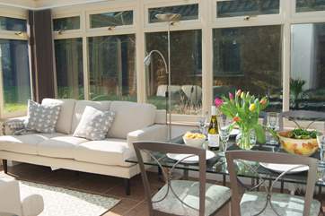 There is a gorgeously sunny conservatory/dining room looking out over the gardens and with French windows to the patio.