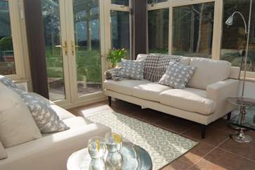 Another view of the living area with its comfortable sofas and garden views.