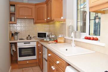 There is a bright,cheerful and very well equipped kitchen with extra light coming through from the conservatory.