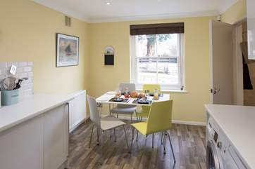 The dining area of the kitchen looks out onto the pretty high street.