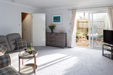 The sitting room opens onto the sheltered courtyard, which leads out to the private parking area for Northgate.