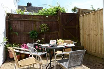 The pretty courtyard garden is very sheltered, three steps lead up to the private parking area.