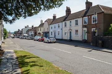 The pretty market town of Wareham, Northgate is in the foreground with the green front door and hanging basket.
