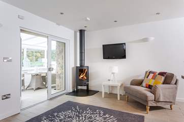 The gorgeous sitting-area has a roaring wood-burner.