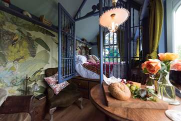 The little dining table is positioned to look straight out the window to the open countryside beyond.