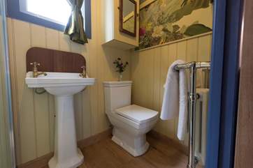 There is a proper flushing toilet and wash-basin and a heated towel rail.