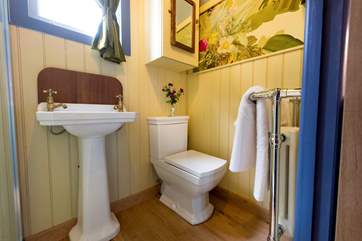 There is a proper flushing toilet and wash-basin and a heated towel rail.