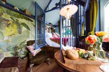 The little dining table is positioned to look straight out the window to the open countryside beyond.