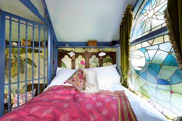 The gorgeous king-size bed has a window at the foot looking out over the countryside.