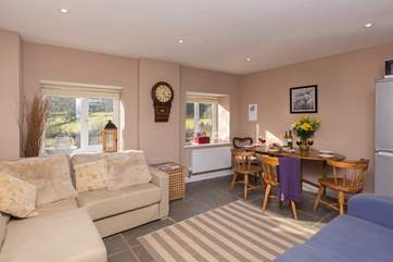 The open plan living and dining area is filled with light and has views right down the valley.