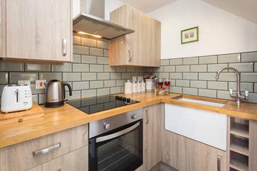 The kitchen is very compact but very stylish! it is to the left as you go in via the terrace door and then the living/dining area opens out to the right.