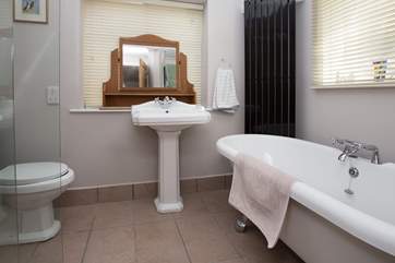 The is the en suite bathroom, with bath and wet-room style shower, for the ground floor bedroom. There are two steps up into the bathroom.