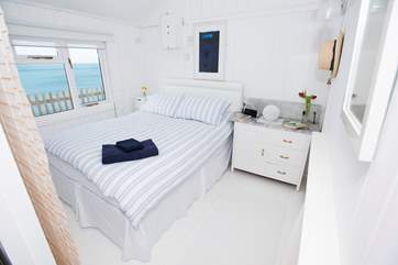 The master bedroom with its comfy king-size bed and a view straight out to sea.