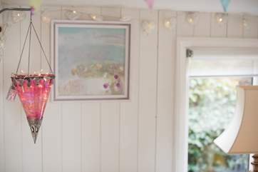 Pretty fairy lights add to the romance of the cabin.