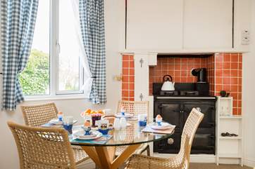 The dining-room is next to the kitchen and features the lovely Rayburn.
