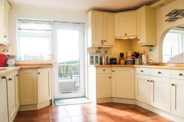 A door leads out from the kitchen to the hot tub decking area.