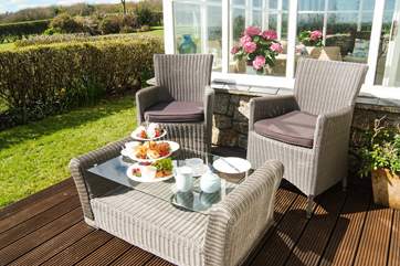 Enjoy a cream tea in the sunshine.