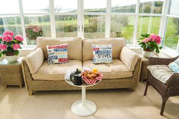The conservatory looks out over the grounds towards the sea.