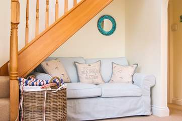 A sofa is tucked under the stairs and the dining-room has a Smart TV.