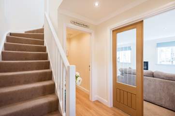 The hallway leads upstairs to the bedrooms and through to the sitting-room, kitchen and dining-room.