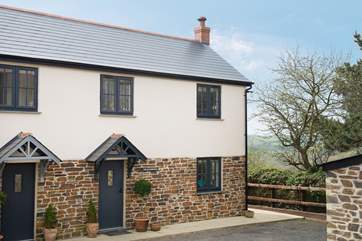 This pretty semi-detached cottage is located at the end of the driveway.